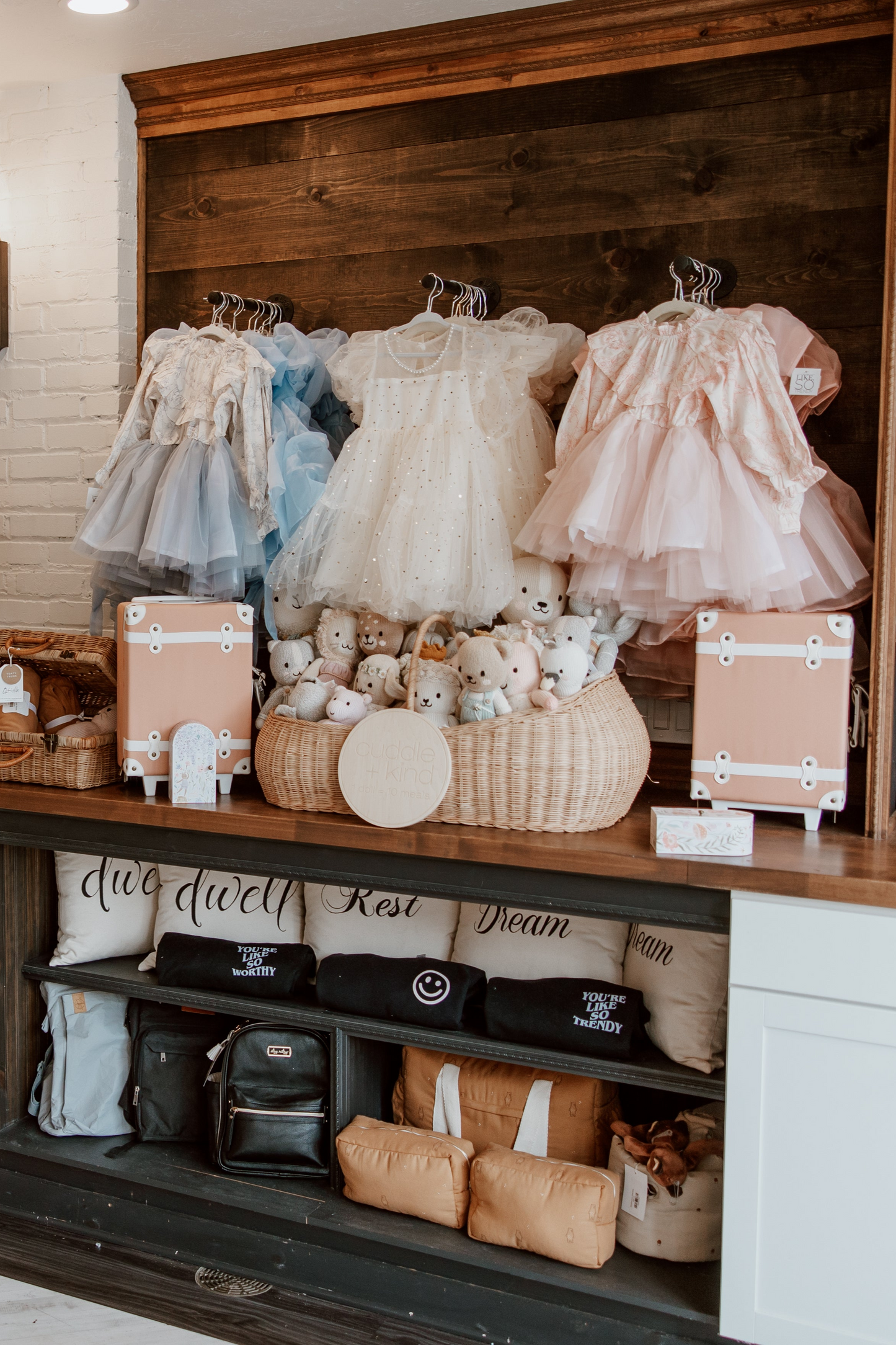 Chic and cozy children's boutique outfits, showcasing a variety of fashionable dresses, rompers, and matching accessories for kids.