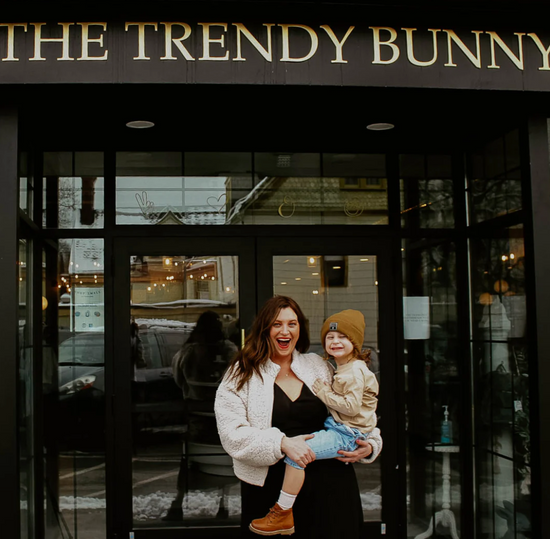 The mama behind Trendy Bunny Studio, smiling and welcoming guests to her creative space designed for children's activities and events.